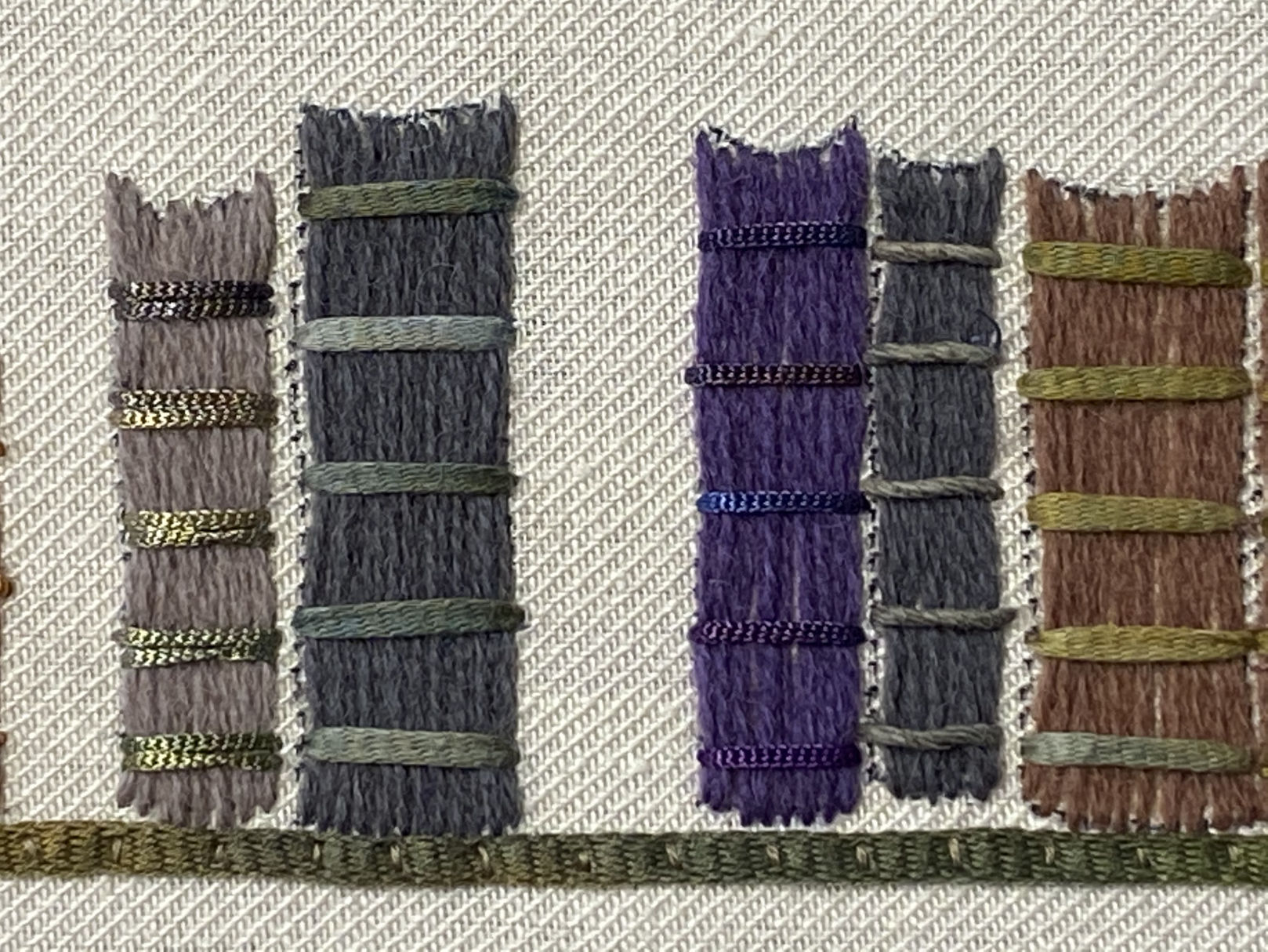 book spines are couched wool with inlaid cotton and ribbon